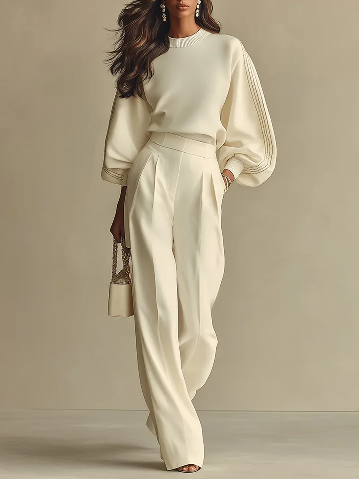 Model wearing elegant ivory knit two-piece set with puff sleeves and wide-leg trousers