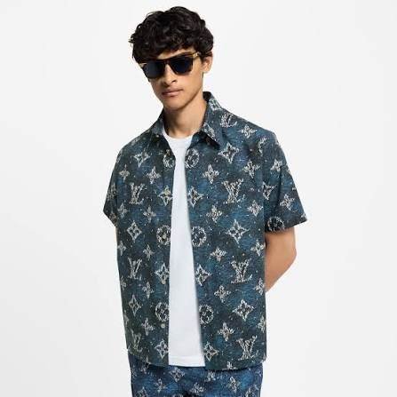 Model wearing a designer monogram short-sleeve shirt from Fazzy Fashion & Designs