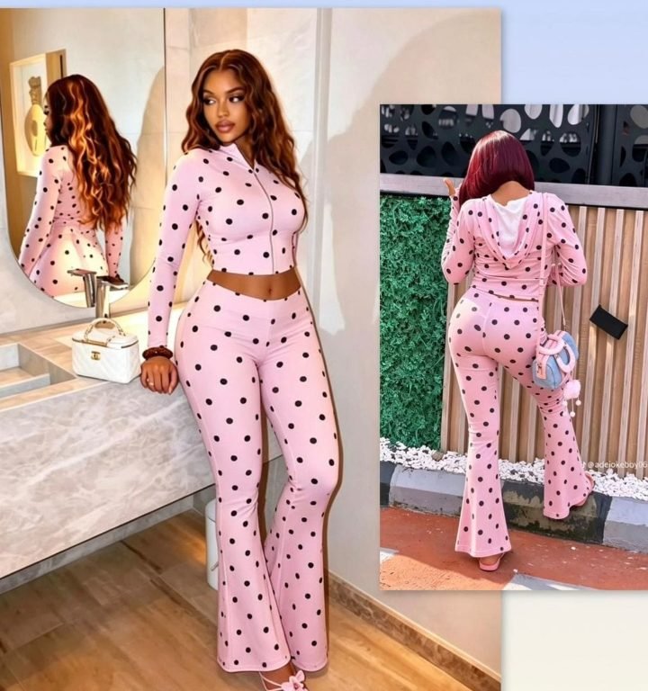 Woman wearing a pink polka dot crop top and flare trousers co-ord set from Fazzy Fashion & Designs